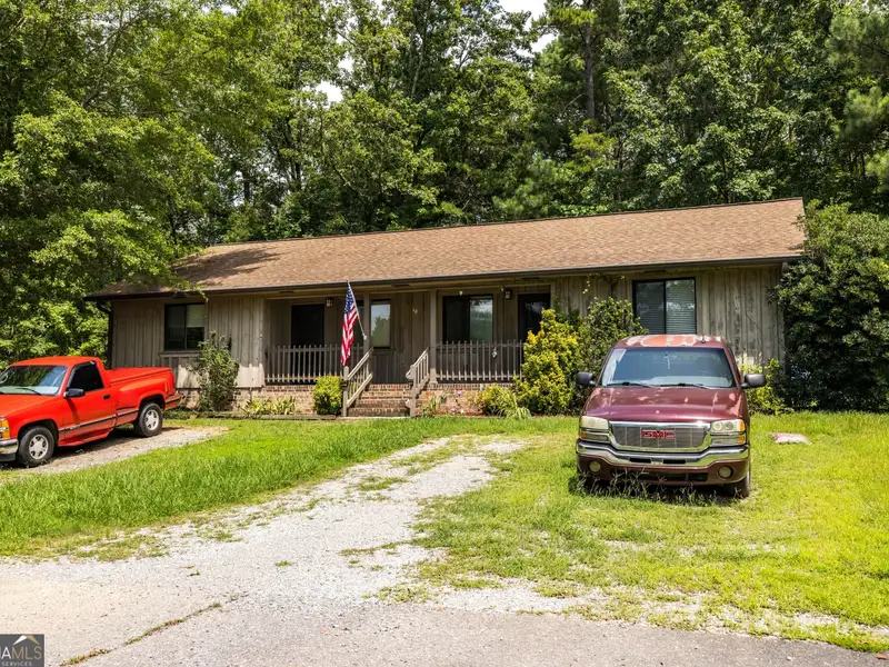 27 Acres with 2,400 Sq. Ft. Home, Duplexes, Pool, and Barn in Prime Location