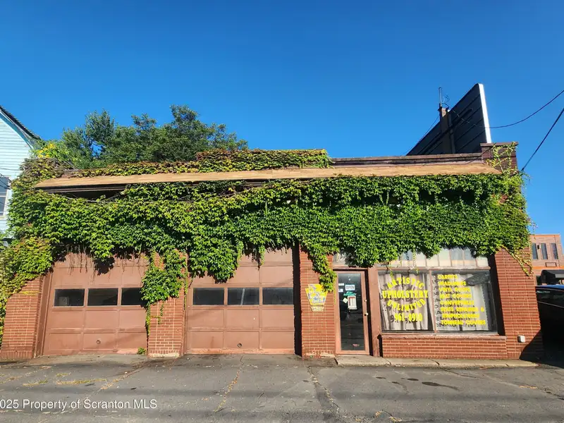 Versatile Commercial Property with Garage Bays and Billboard Income in Prime Location