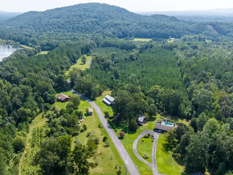 27 Acres with 2,400 Sq. Ft. Home, Duplexes, Pool, and Barn in Prime Location