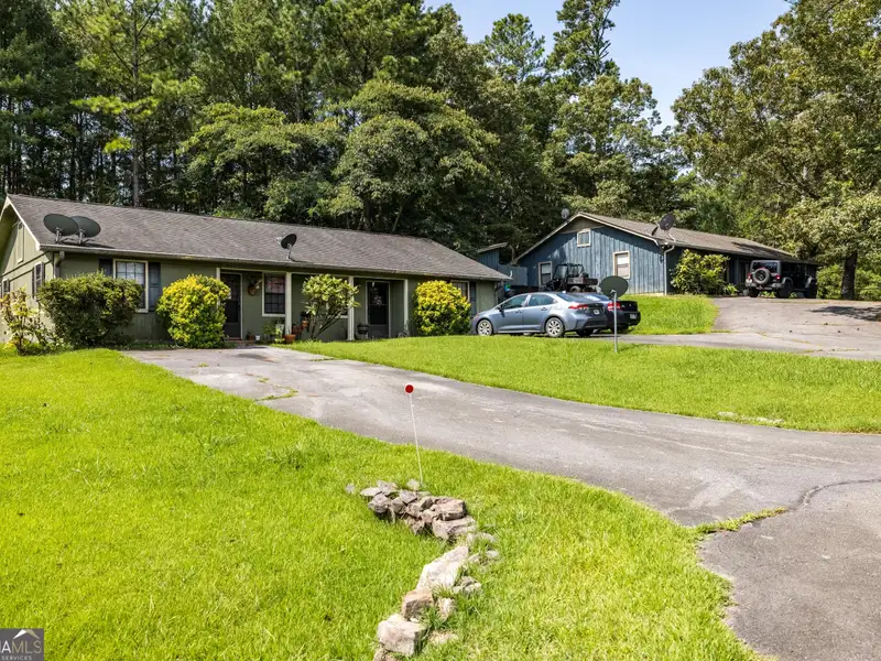 27 Acres with 2,400 Sq. Ft. Home, Duplexes, Pool, and Barn in Prime Location