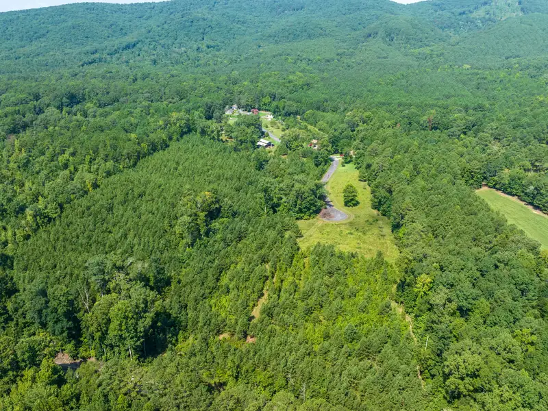 27 Acres with 2,400 Sq. Ft. Home, Duplexes, Pool, and Barn in Prime Location