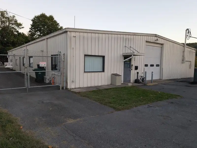 Commercial Automotive Facility with Lifts, Engine Room, and Ample Parking in Fenced Lot