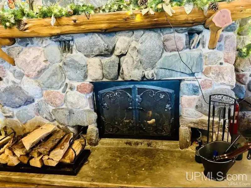 Full Log Home with Acreage, Pond, and Rental Income Near Ski Hills and Lake Superior