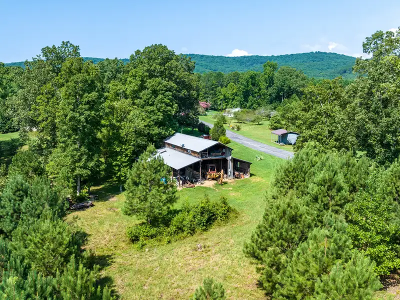 27 Acres with 2,400 Sq. Ft. Home, Duplexes, Pool, and Barn in Prime Location