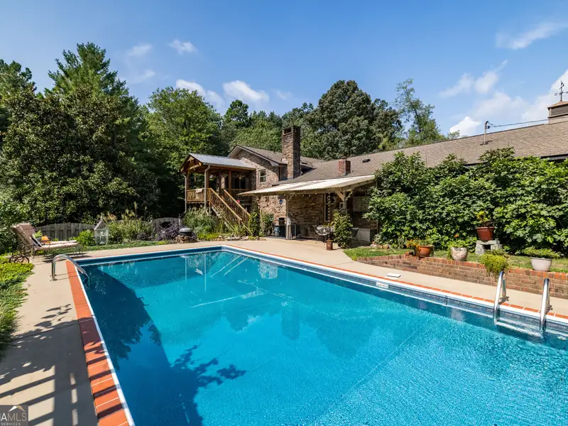 27 Acres with 2,400 Sq. Ft. Home, Duplexes, Pool, and Barn in Prime Location