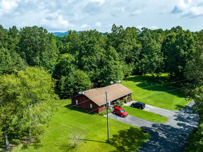 27 Acres with 2,400 Sq. Ft. Home, Duplexes, Pool, and Barn in Prime Location