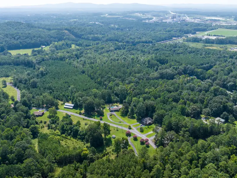 27 Acres with 2,400 Sq. Ft. Home, Duplexes, Pool, and Barn in Prime Location