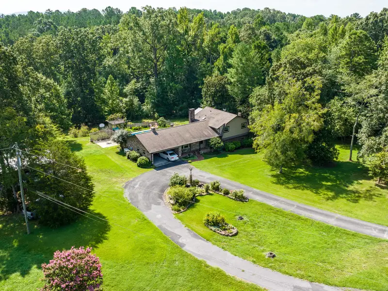 27 Acres with 2,400 Sq. Ft. Home, Duplexes, Pool, and Barn in Prime Location