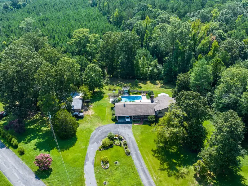 27 Acres with 2,400 Sq. Ft. Home, Duplexes, Pool, and Barn in Prime Location