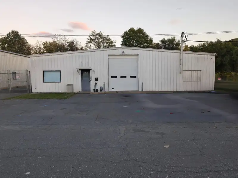 Commercial Automotive Facility with Lifts, Engine Room, and Ample Parking in Fenced Lot