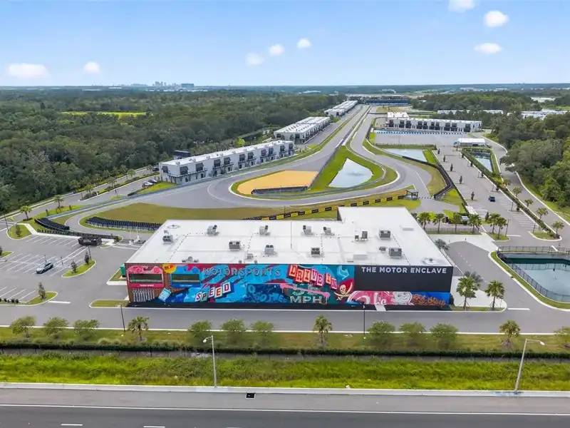 Exclusive Balcony Unit at the Motor Enclave with Private Garage and Racetrack Views