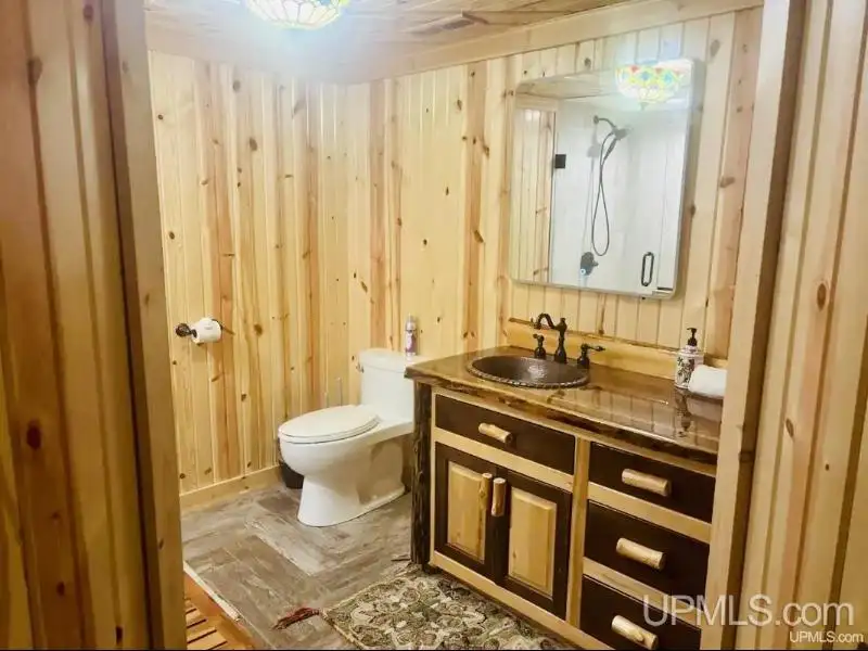 Full Log Home with Acreage, Pond, and Rental Income Near Ski Hills and Lake Superior
