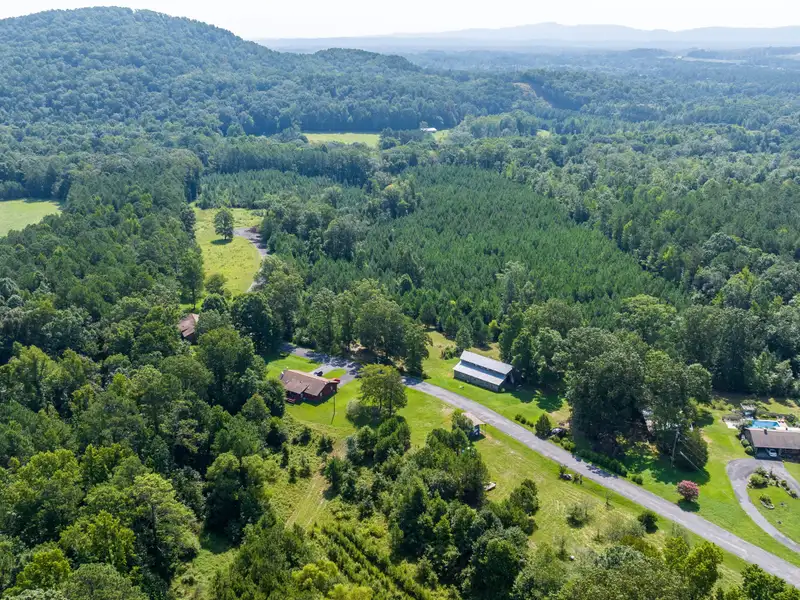 27 Acres with 2,400 Sq. Ft. Home, Duplexes, Pool, and Barn in Prime Location