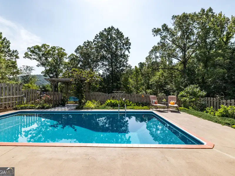 27 Acres with 2,400 Sq. Ft. Home, Duplexes, Pool, and Barn in Prime Location