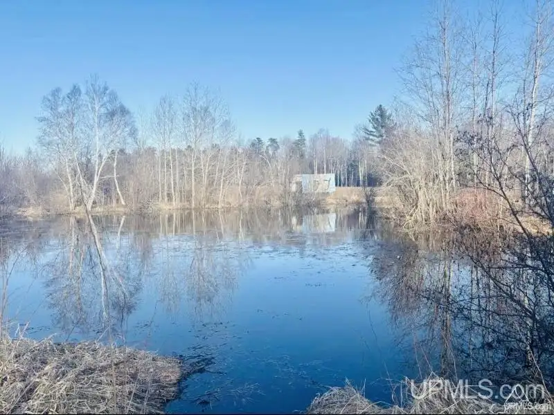 Full Log Home with Acreage, Pond, and Rental Income Near Ski Hills and Lake Superior