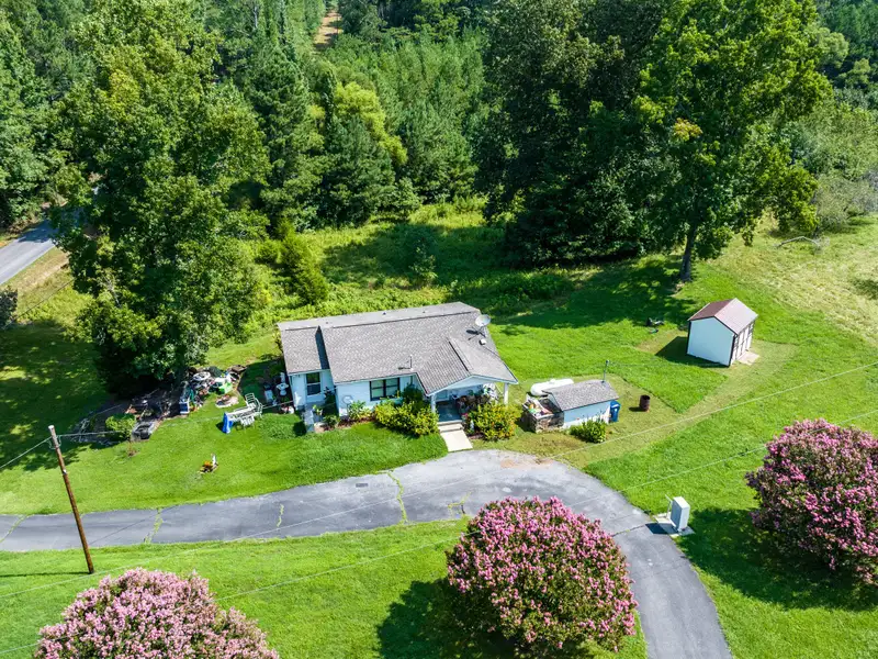 27 Acres with 2,400 Sq. Ft. Home, Duplexes, Pool, and Barn in Prime Location