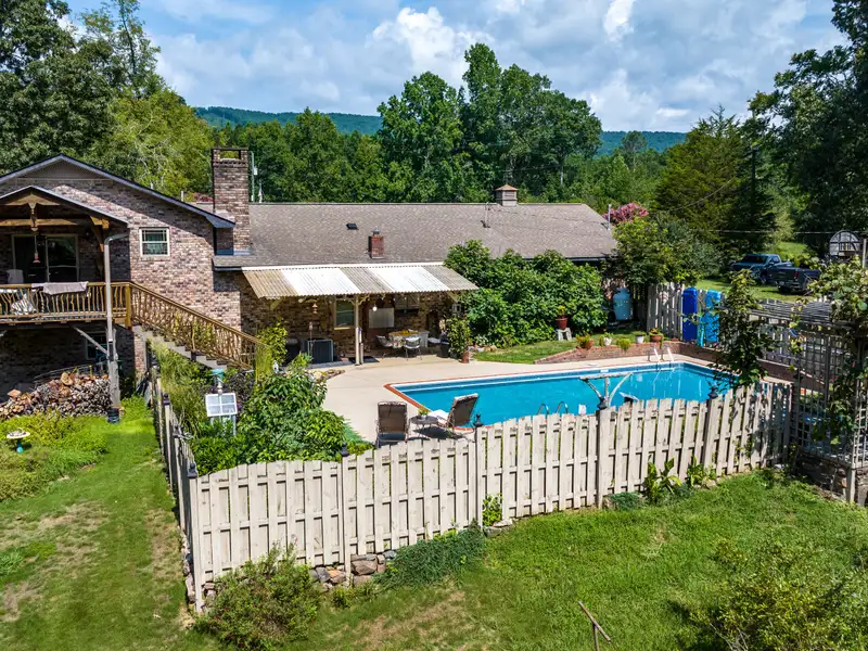 27 Acres with 2,400 Sq. Ft. Home, Duplexes, Pool, and Barn in Prime Location
