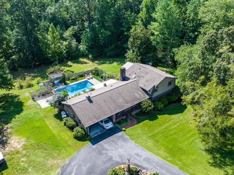 27 Acres with 2,400 Sq. Ft. Home, Duplexes, Pool, and Barn in Prime Location