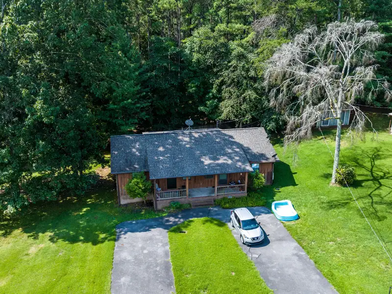 27 Acres with 2,400 Sq. Ft. Home, Duplexes, Pool, and Barn in Prime Location