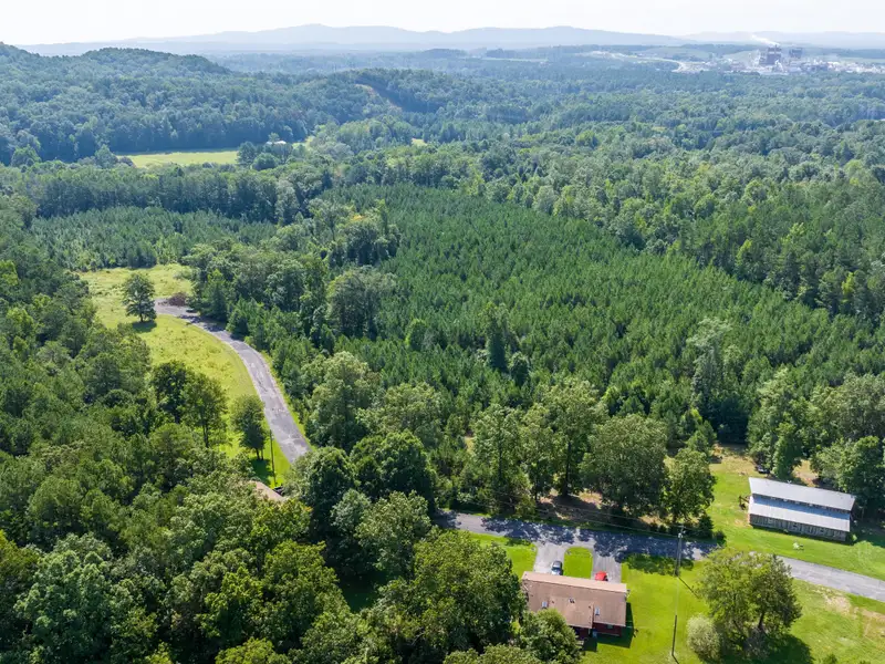 27 Acres with 2,400 Sq. Ft. Home, Duplexes, Pool, and Barn in Prime Location