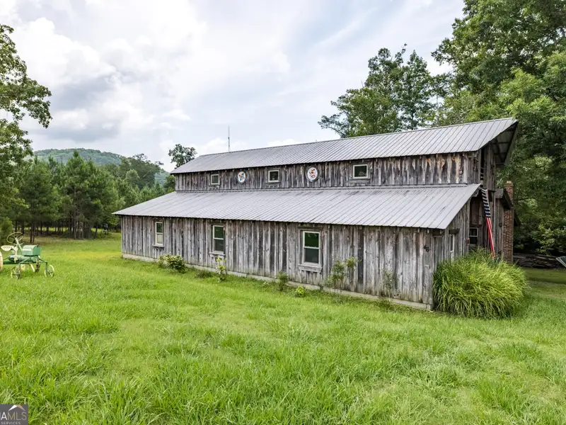 27 Acres with 2,400 Sq. Ft. Home, Duplexes, Pool, and Barn in Prime Location