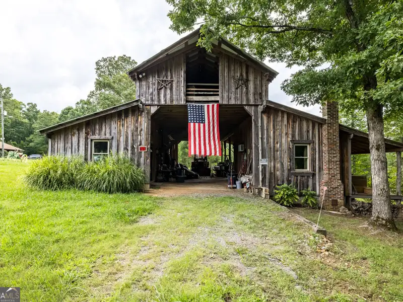 27 Acres with 2,400 Sq. Ft. Home, Duplexes, Pool, and Barn in Prime Location
